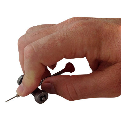 Hand holding a Watchmakers Screwdriver Sharpening Tool with a screwdriver