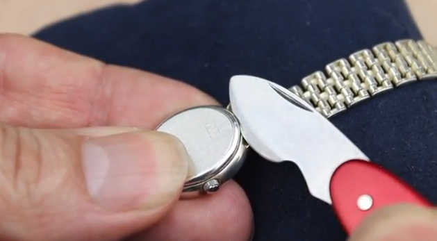 Swiss Watch Case Opener Knife opening up the back of a watch