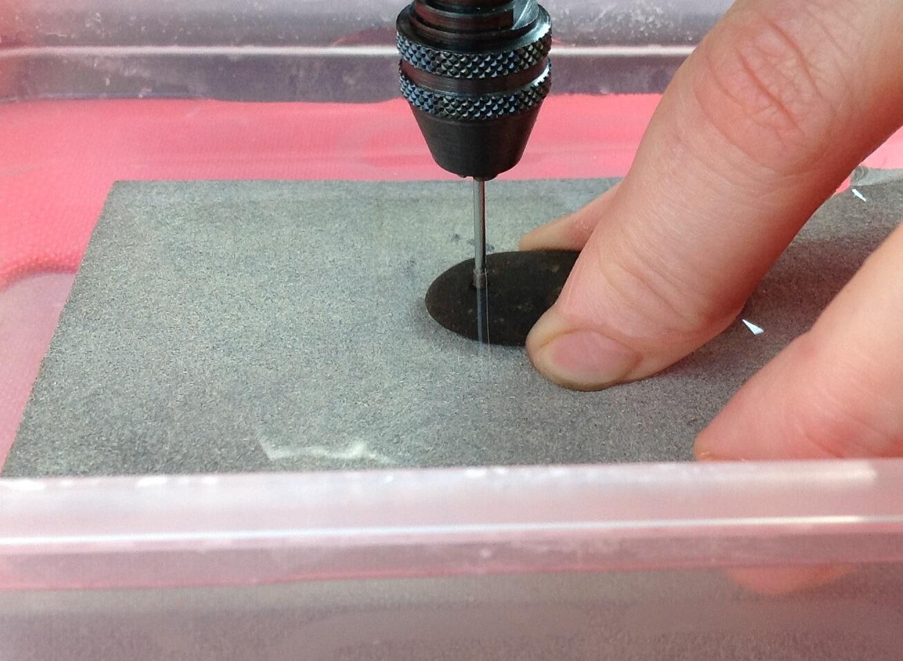 Using a rotary tool with small diamond drill bit to drill through stone or shell
