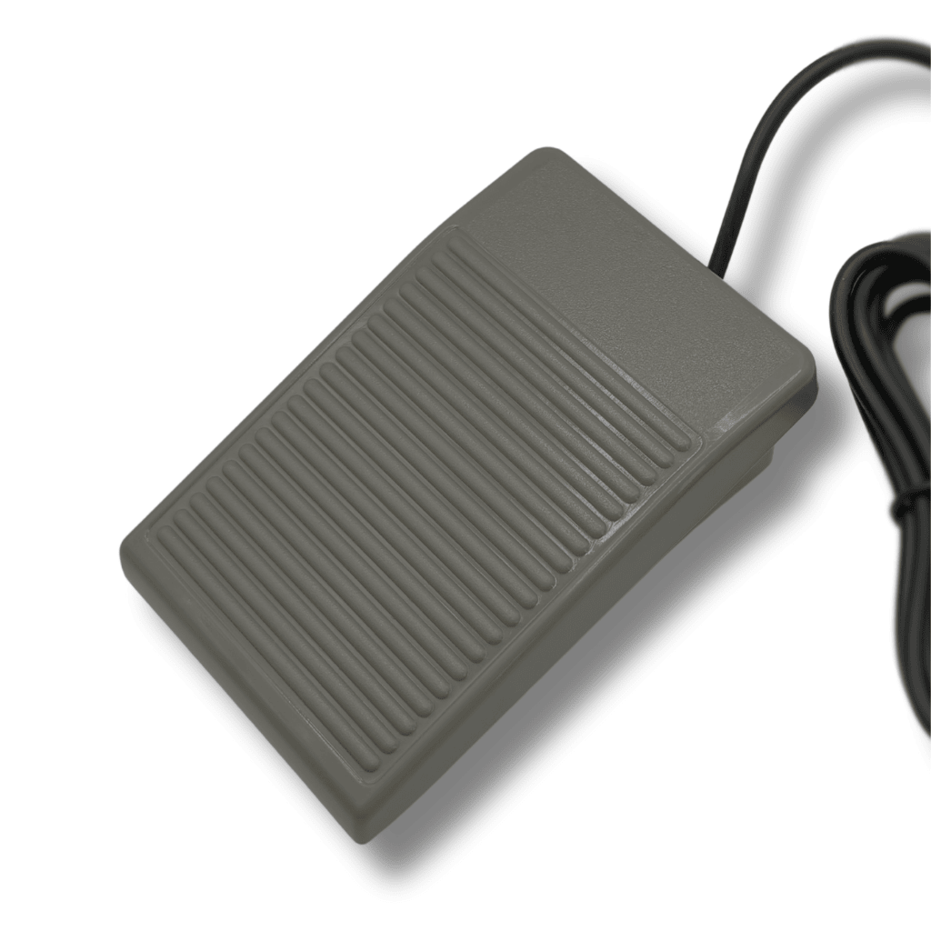 Grey foot pedal with a cable on a white background