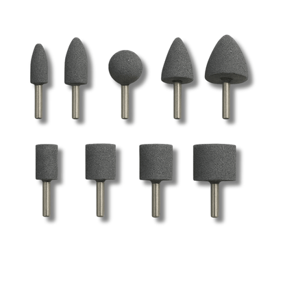 Nine assorted shapes of mounted, grey aluminium oxide corundum grinding stone points on a whote background