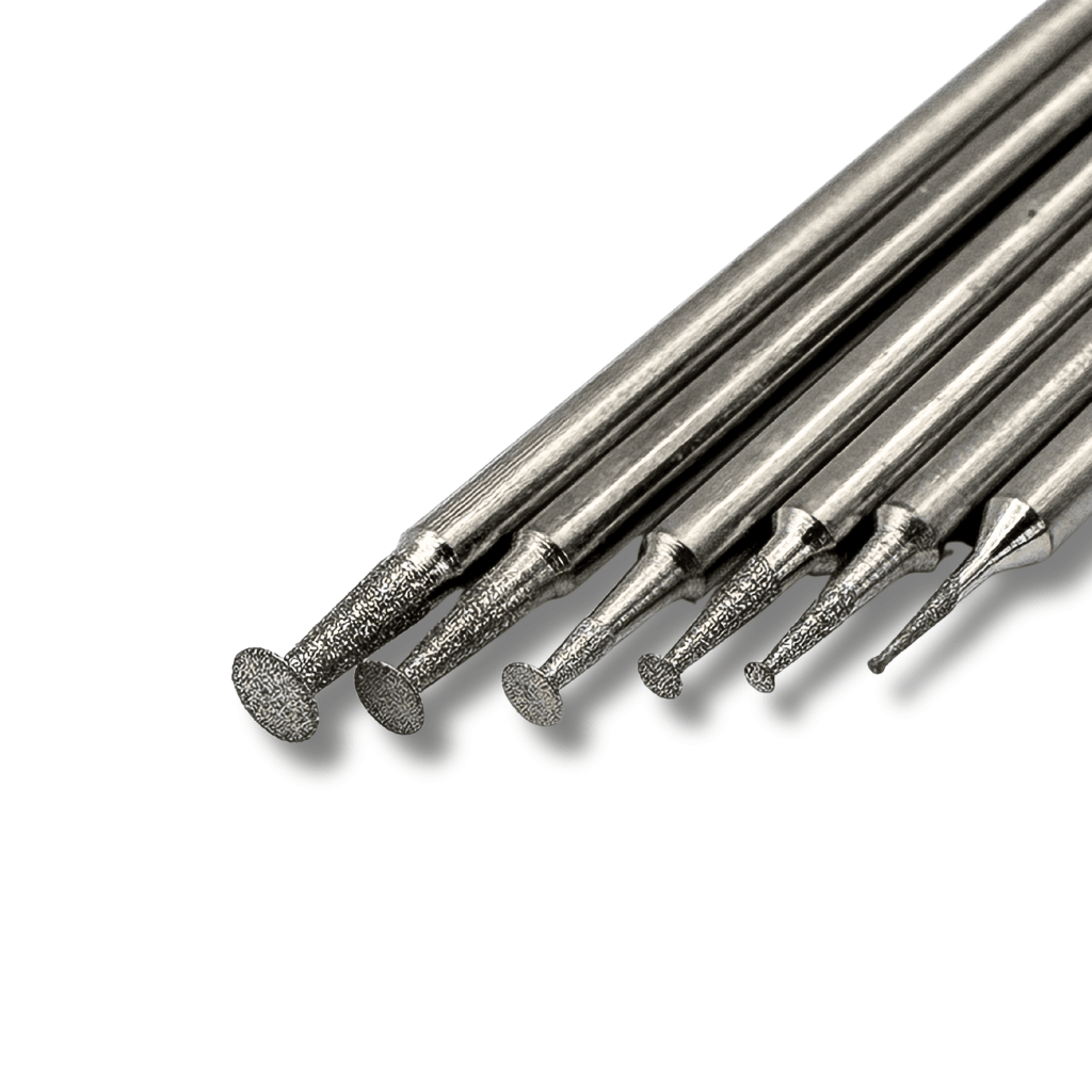 Close up view of the tips of six small diamond disc burrs mounted on a 2.35mm shank for engraving and carving glass, stone and gemstones