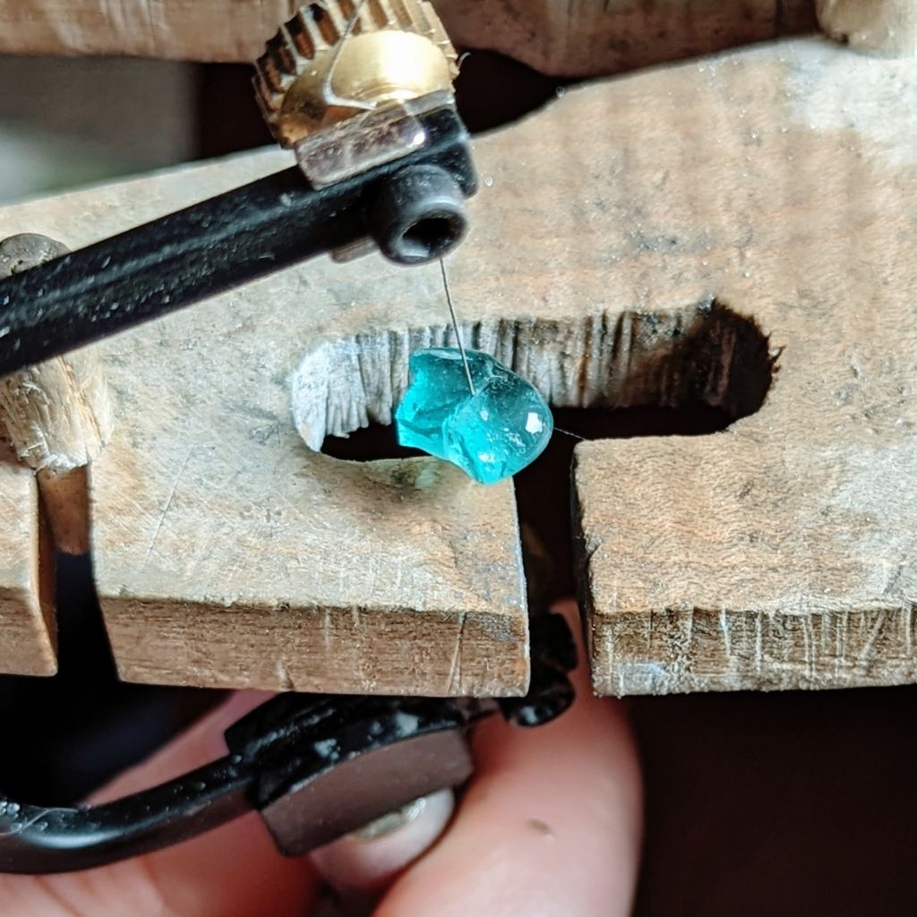 Diamond wire saw blades in a saw frame cutting a blue stone