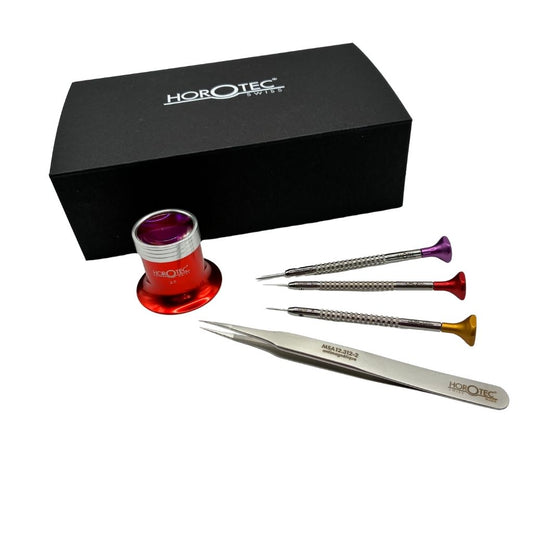 Horotec watchmaking kit with presentation box showing three screwdrivers, tweezers and a red eyeglass displayed together on white background